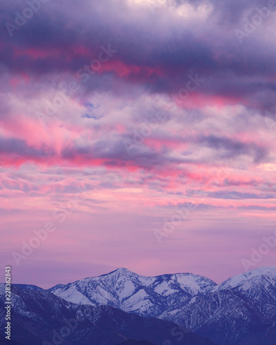 Clouds over a snow capped mountain