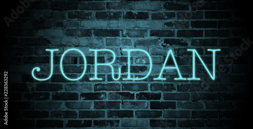 first name Jordan in blue neon on brick wall
