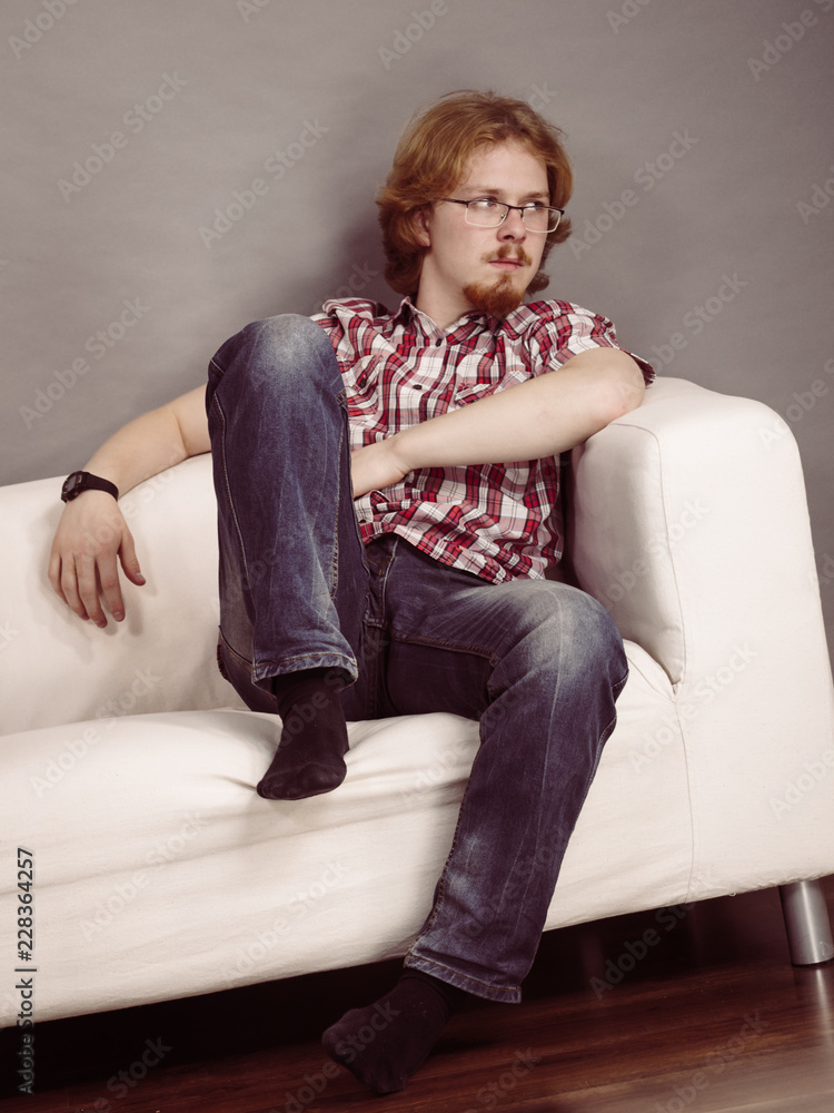 Young man thinking and sitting Young man thinking and sitting