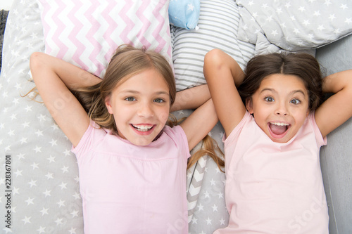Consider theme slumber party. Slumber party timeless childhood tradition. Girls relaxing on bed. Slumber party concept. Girls just want to have fun. Invite friend for sleepover. Best friends forever