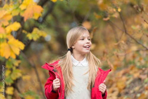 Feeling protected at this autumn day. Happy childhood. Small child with autumn leaves. Happy little girl in autumn forest. Autumn fashion. So beautiful. Feeling free and relaxed. Follow me