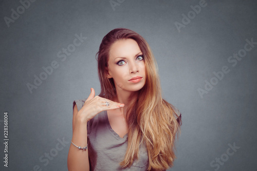 Angry woman showing cut it out stop it hand gesture