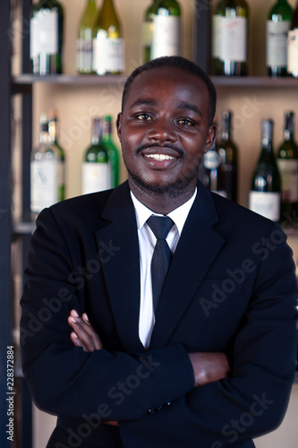 African business man smiling in wine shop