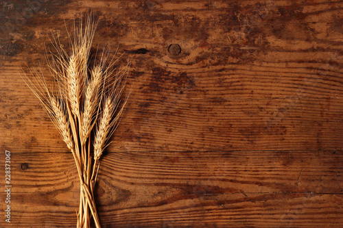 Ears of wheat on wooden background