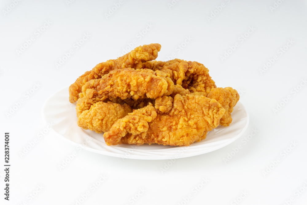 Fried breaded chicken fillet isolated on white background with selective focus and crop fragment Fried breaded chicken fillet isolated on white background with selective focus and crop fragment
