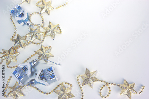 Blue snow-covered houses and necklace with stars. Christmas and New Year holiday background concept. Blank space for text.
