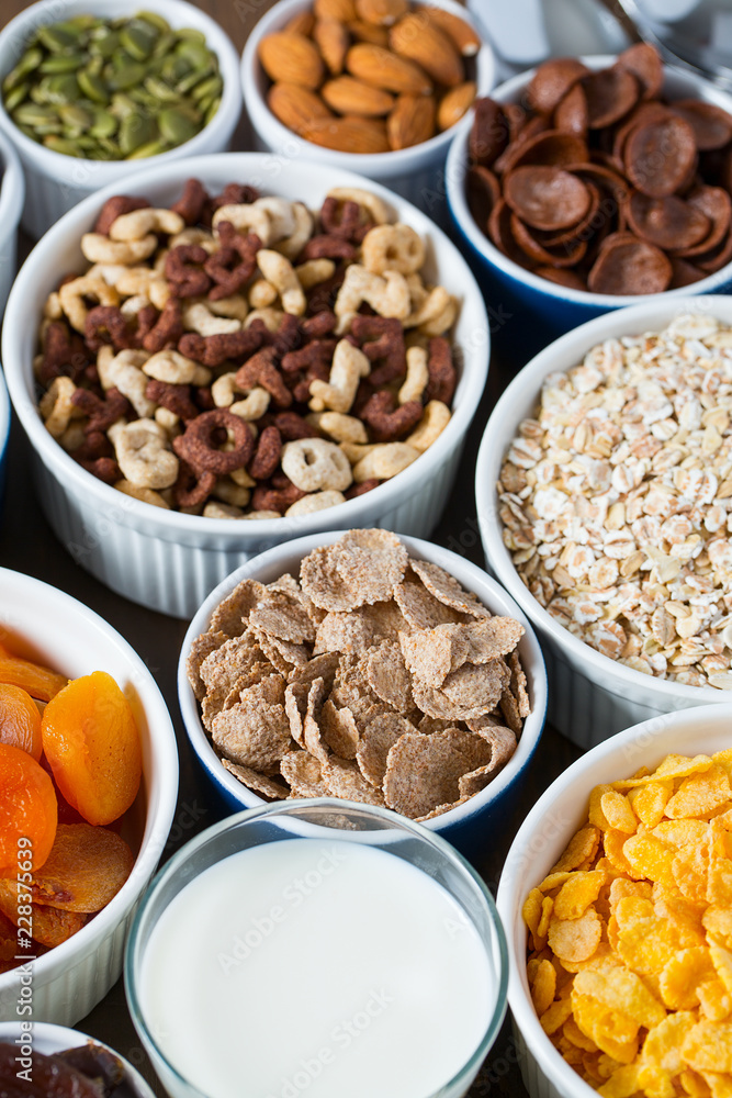 various cereals, nuts and dried fruits on wooden surface various cereals, nuts and dried fruits on wooden surface