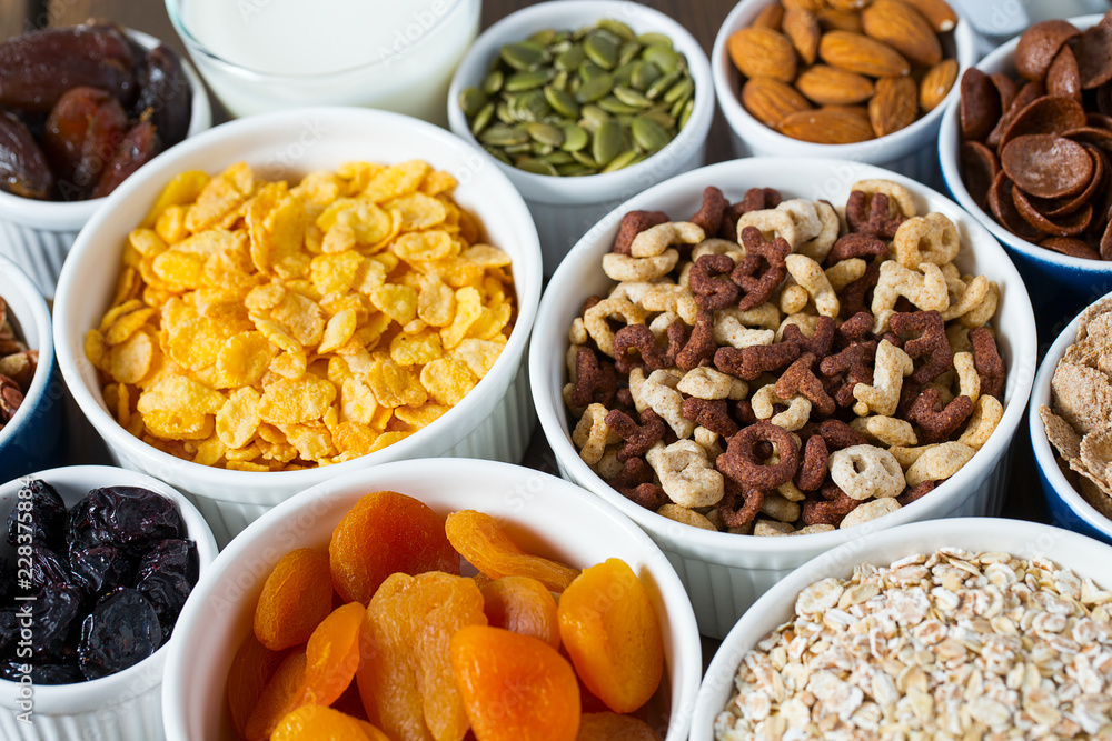 various cereals, nuts and dried fruits on wooden surface various cereals, nuts and dried fruits on wooden surface