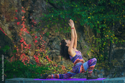 young woman practice yoga outdoor colorful autumn background