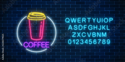 Neon glowing sign of coffee cup in circle frame with alphabet. Fastfood light billboard sign. Cafe menu item.