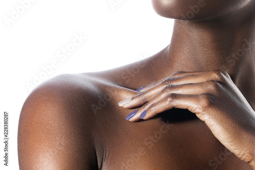 Palm on shoulder of young beautiful black woman with clean perfect skin