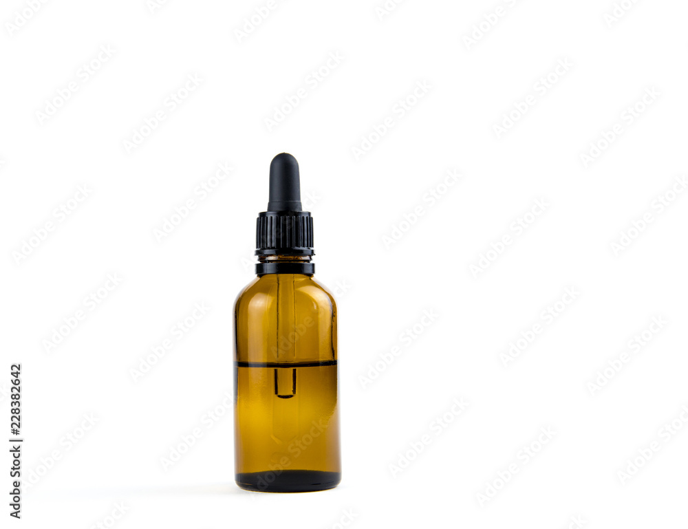 Small brown medical pipette glass bottle isolated on white background. A lot of empty room and space for text. Small brown medical pipette glass bottle isolated on white background. A lot of empty room and space for text.