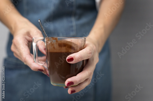 woman's hands close up holding a cup of chocolate