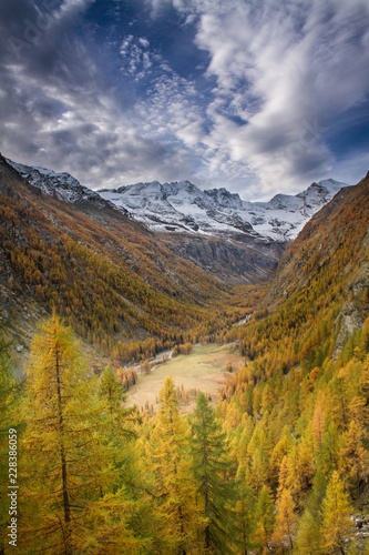 Great view of valley in Gran Paradiso National Park, Alps, Italy, dramatic scene, beautiful world. colourful autumn and mountains covered by snow,scenic view with cloudy sky, wallpaper