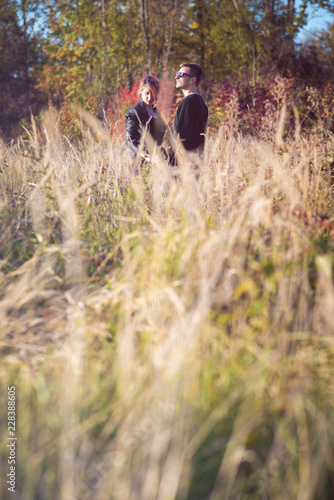 Young couple hugging in autumn nature setting