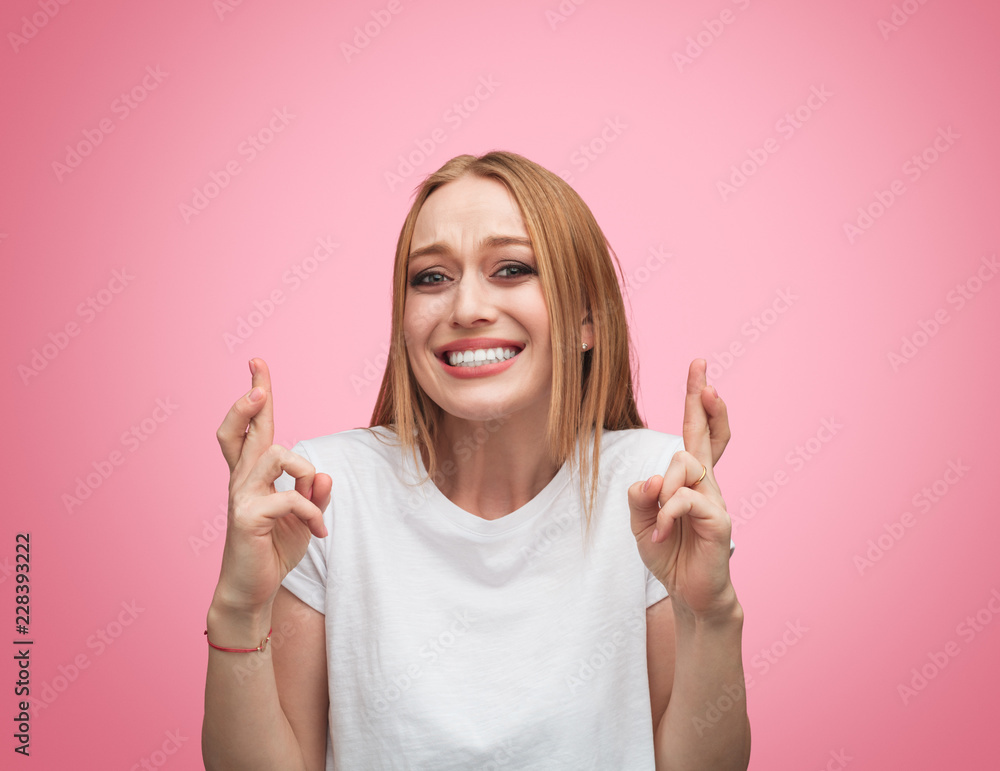 Hopeful woman crossing fingers for luck Hopeful woman crossing fingers for luck