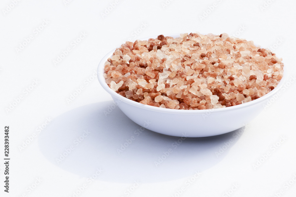 close-up in white container filled with granulated pink salt close-up in white container filled with granulated pink salt