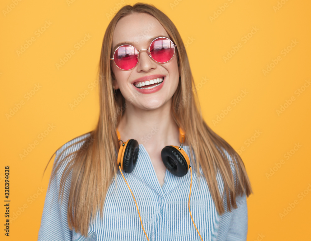 Trendy hipster woman in headphones and sunglasses Trendy hipster woman in headphones and sunglasses