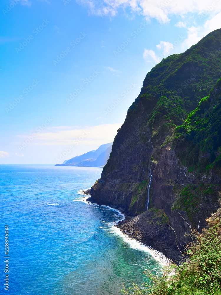 Fototapeta premium Waterfall and cliff near Seixal on Madeira