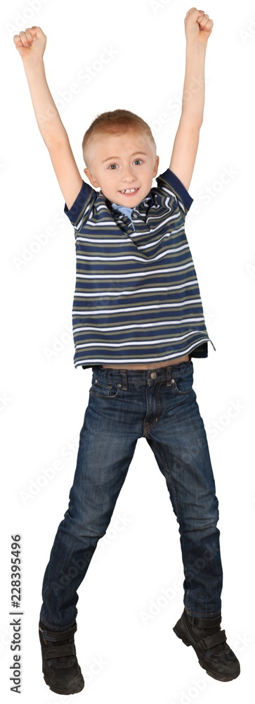 Young boy celebrating with arms in the air Young boy celebrating with arms in the air
