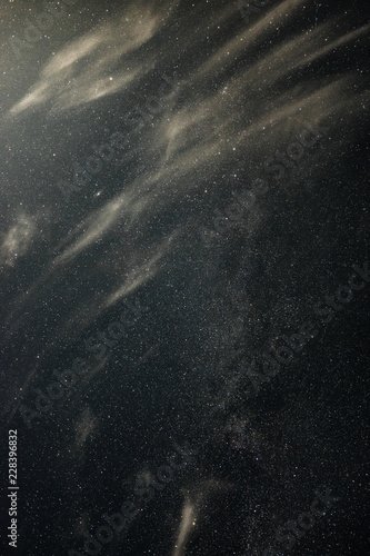 Clouds in the moonlight against the milky way summer night