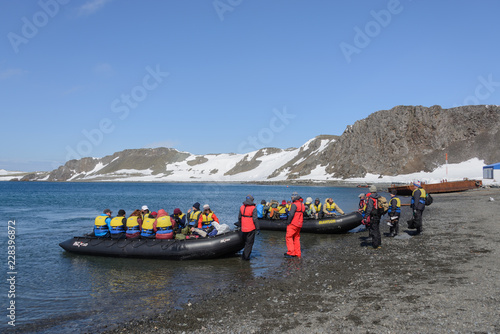 Bellingshausen Russian Antarctic research station, King George island, Antarctica - December 28, 2015: Tourists ready for sail to vessel in inflatable boats