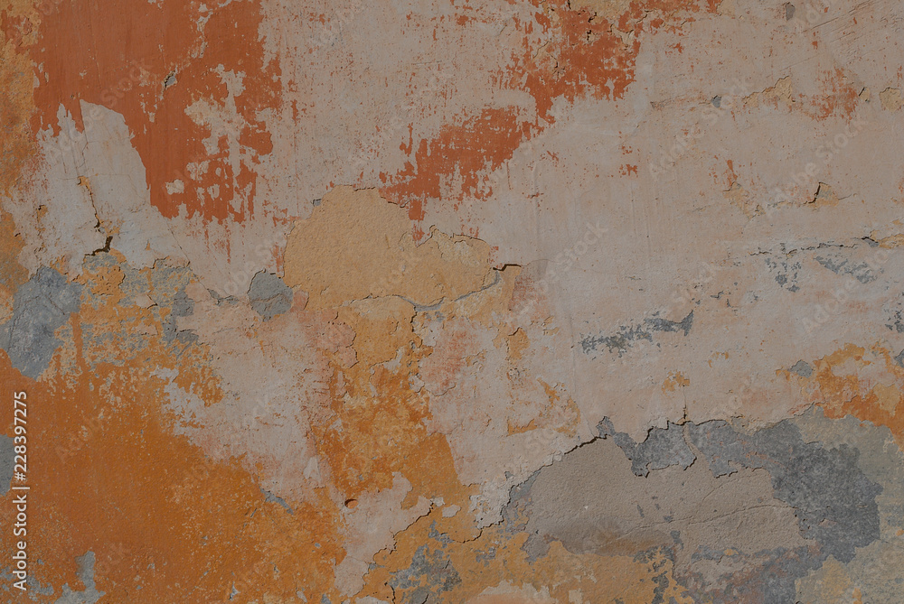 surface of the old wall with exfoliating and falling off paint as a background or texture, yellow texture