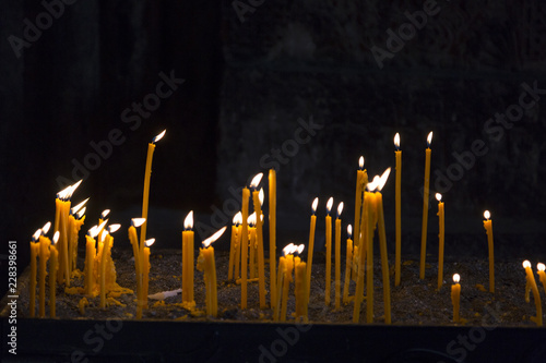 Burning wax candles in the church