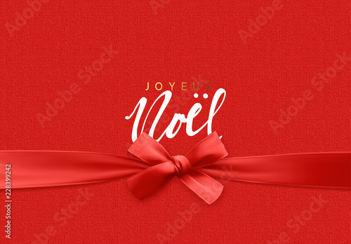 French lettering Joyeux Noel. Merry Christmas Holiday background. Handwritten text, realistic textured pattern, pull ribbon bow.