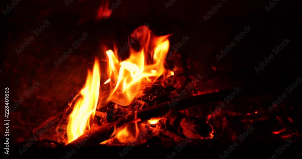 Super Slow shot of a smaller burning eye in a close-up view of the center of the wood that is just burning in the late hours of the day. Super Slow shot of a smaller burning eye in a close-up view of the center of the wood that is just burning in the late hours of the day.