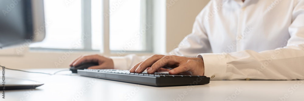 Businessman using computer keyboard Businessman using computer keyboard