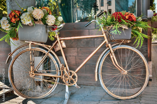 Old vintage bicycle decorated with flowers outdoors