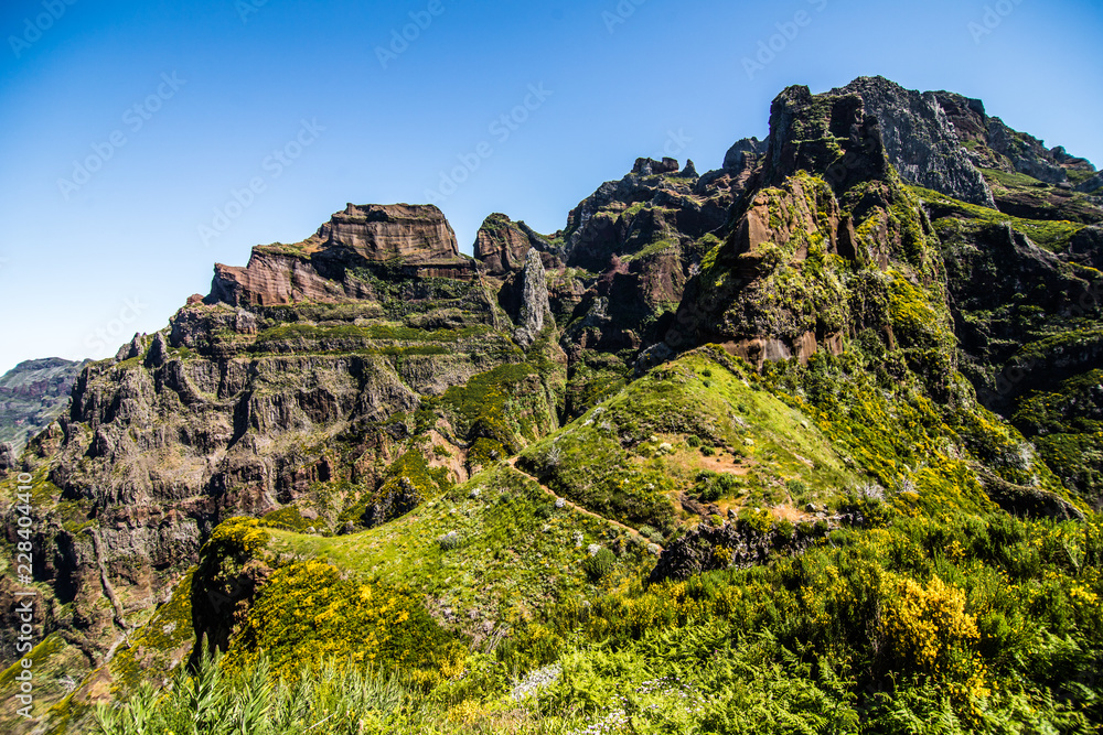 Fototapeta premium Colorful mountain ridge path with volcanic formations beside, Pico do Arieiro, Madeira, Portugal