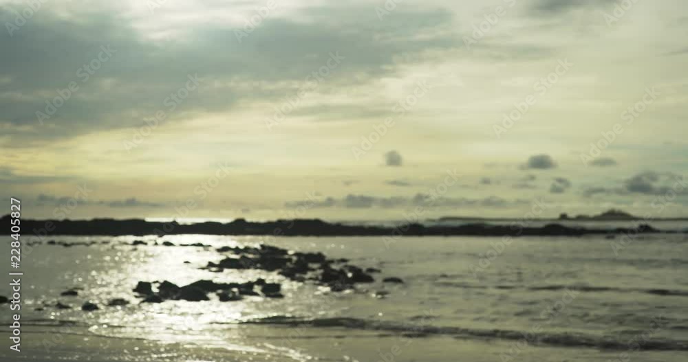 Calm sea waves breaking on rugged coastline close to sunset Calm sea waves breaking on rugged coastline close to sunset