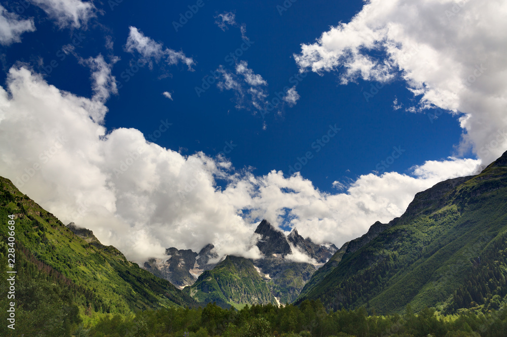 Clouds over the rocky ridge of the mountainous region of the North Caucasus in Russia.