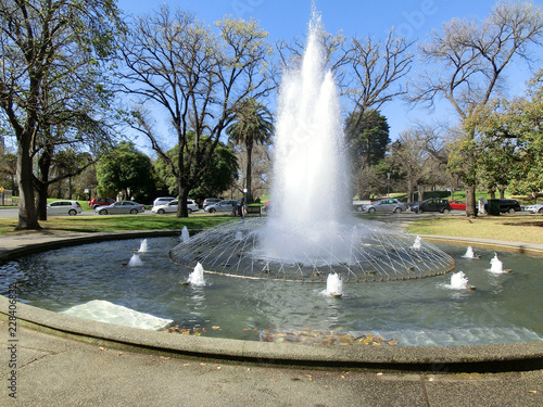 Beautiful fountain in botanic garden with spring trees, Melbourne, Victoria, Australia
