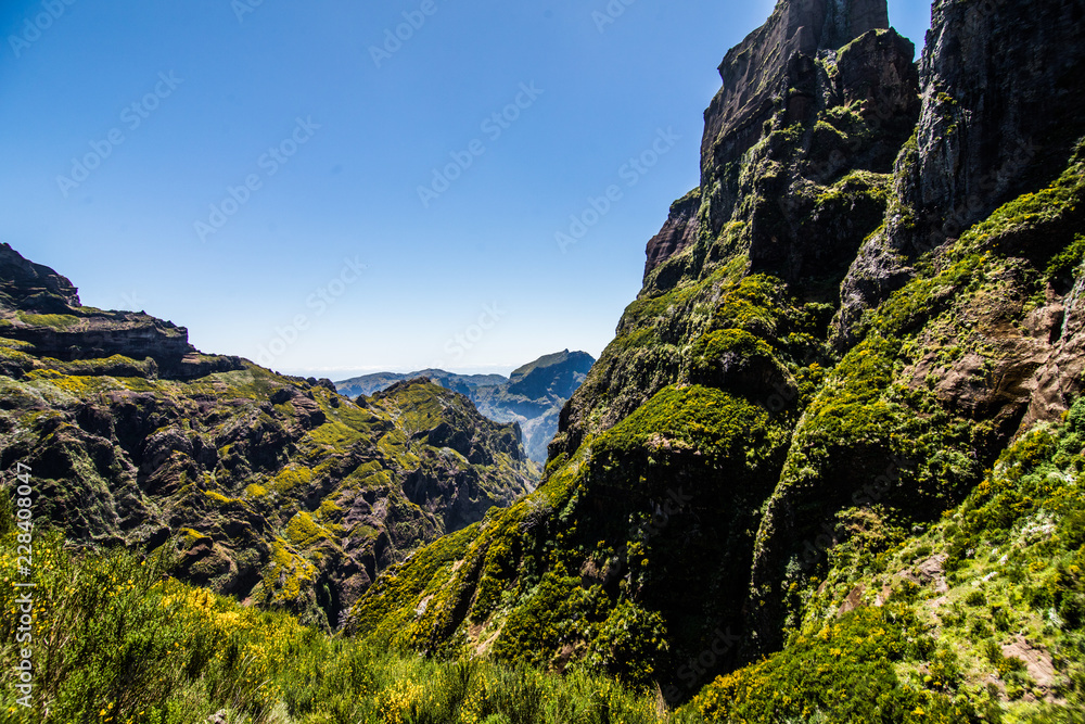 Active lifestyle. Hiking on the beautiful but dangerous hard trekking trail leading from Pico Arieiro peak to the highest mountain of Madeira island, Pico Ruivo