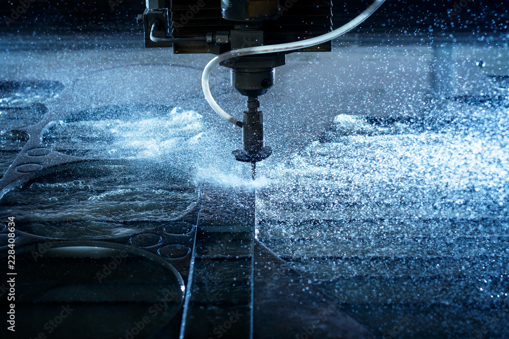 Water jet industrial machine cutting steel plate. Computer controlled metalworking machine using high pressure water jet to cut metal. - obrazy, fototapety, plakaty 
