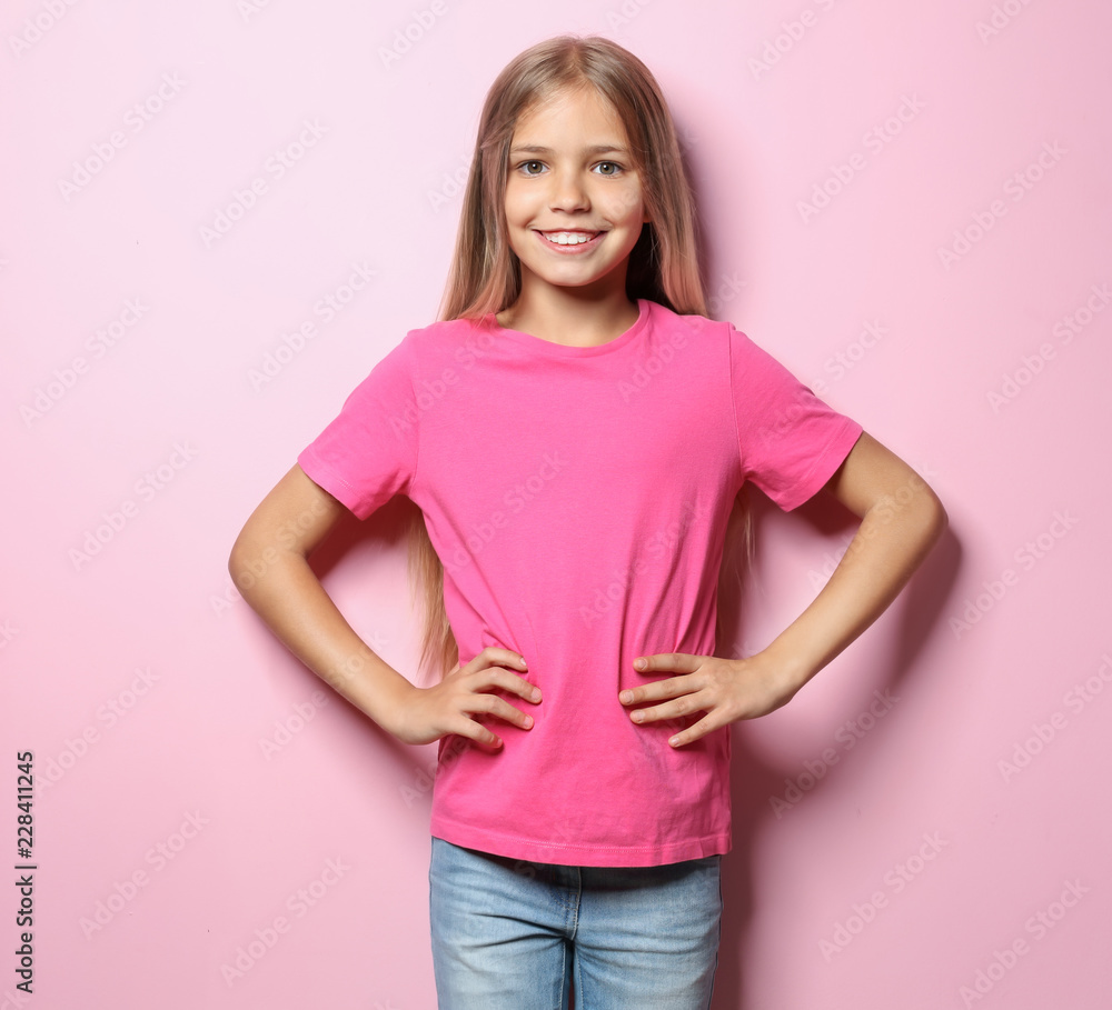 Smiling little girl in t-shirt on color background Smiling little girl in t-shirt on color background