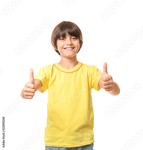 Little boy in t-shirt showing thumb-up gesture on white background