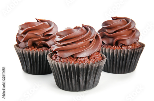 Delicious chocolate cupcakes on white background