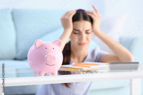 Piggy bank on table of youn...