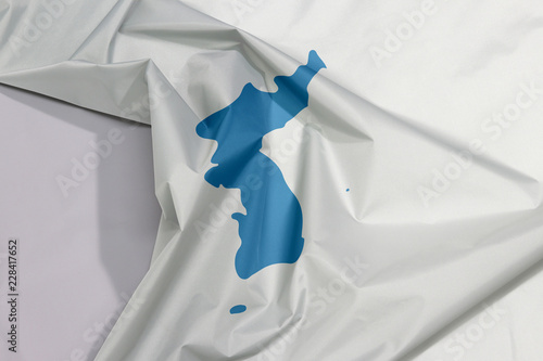 Unification Korea fabric flag crepe and crease with white space, Korean Peninsula in blue on white.