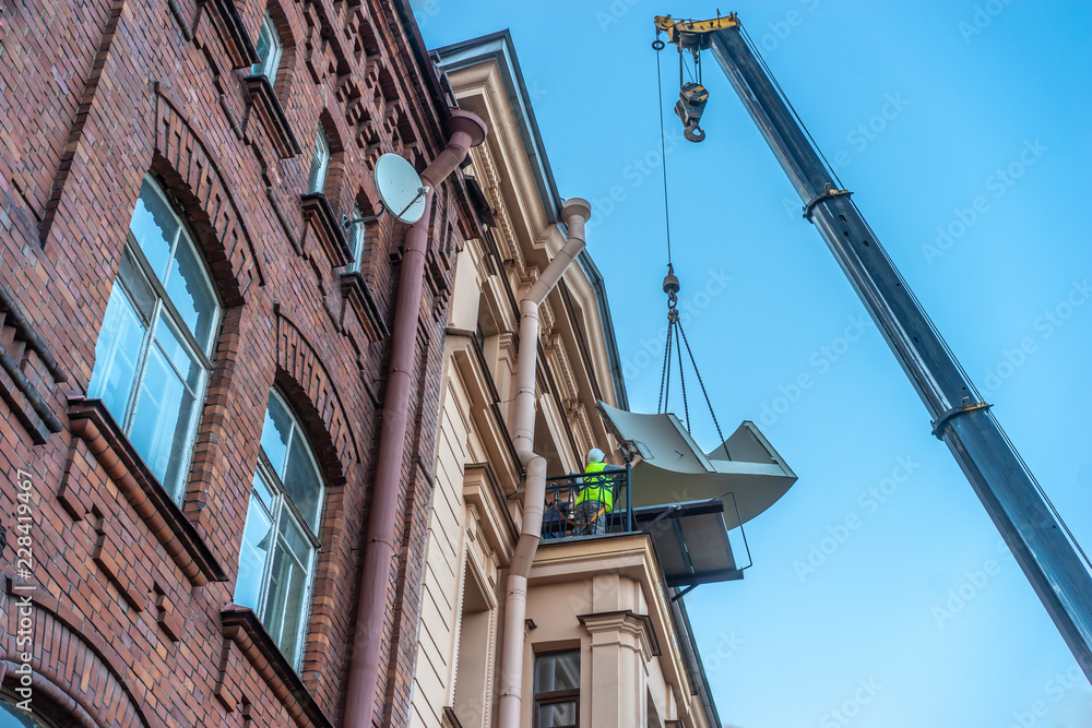 The crane lifts the load. Loading oversized materials. Truck crane lifts the metalwork. Construction work at height. The crane lifts the load. Loading oversized materials. Truck crane lifts the metalwork. Construction work at height.