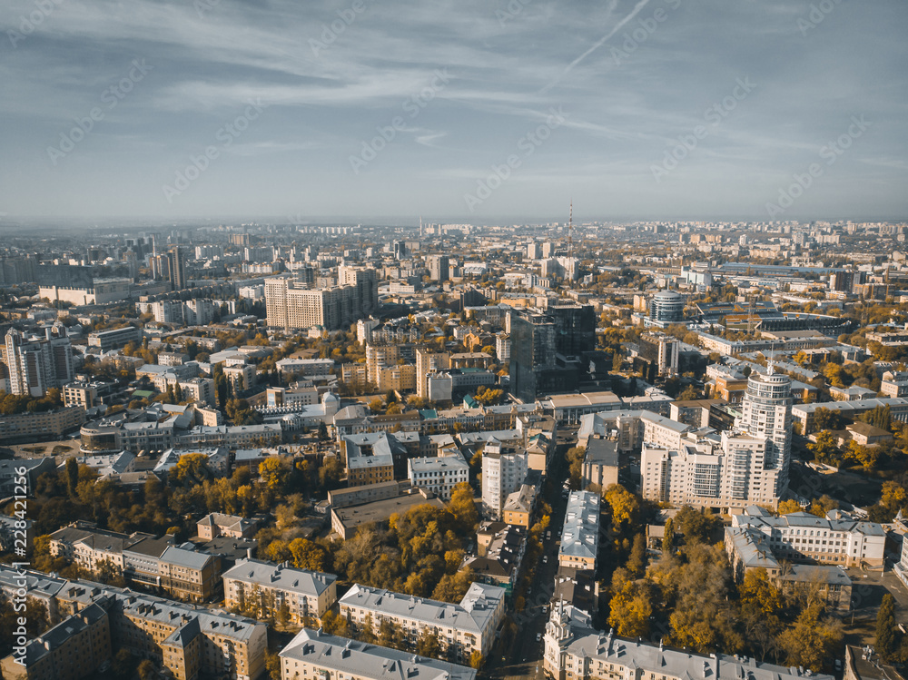 Aerial drone shot of Voronezh downtown with buildings from above, parks, streets with cars in sunny autumn day