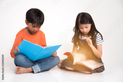 Two children siit and reading book at school,fun and happy,education concept,learning and knowlage.white background. photo