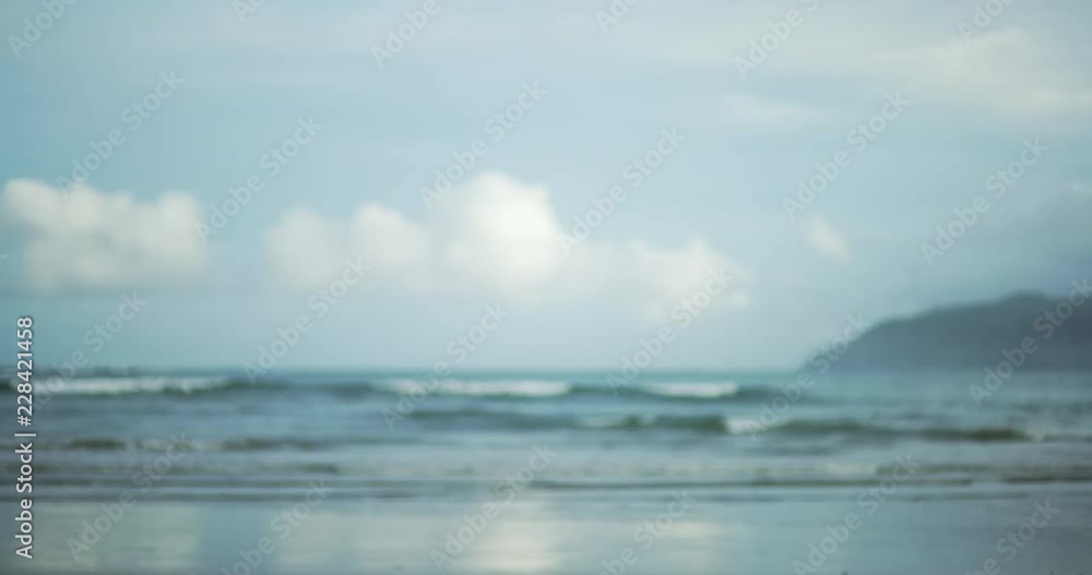 Blurred shot of beautiful clouds and low tide waves on tropical beach Blurred shot of beautiful clouds and low tide waves on tropical beach