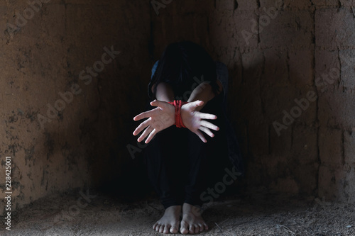 Kidnapped little girl tied with rope.Abused and tortured concept. Human trafficking concept. Stop violence against Women. International women's Day. Stop abusing violence. photo