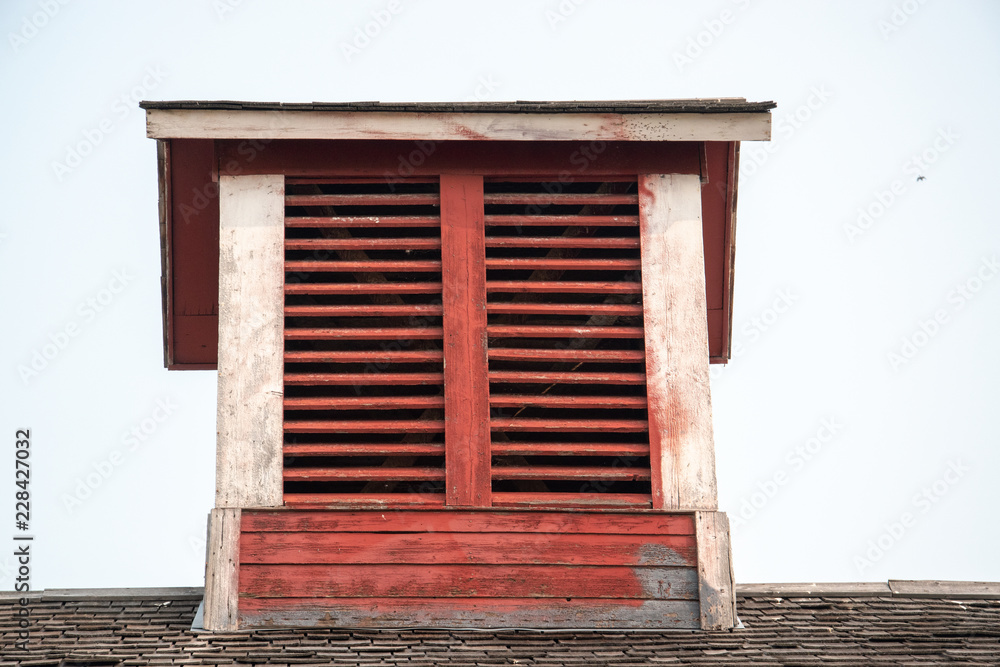 Old red barn with rustic weathered cupola Old red barn with rustic weathered cupola