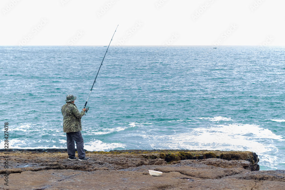 Man fishing in the cliff